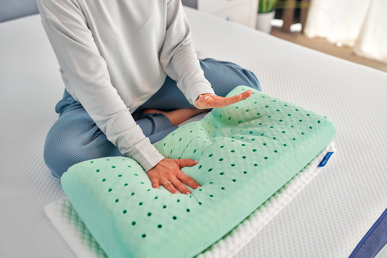 La mujer prueba el relleno de la almohada V1A
